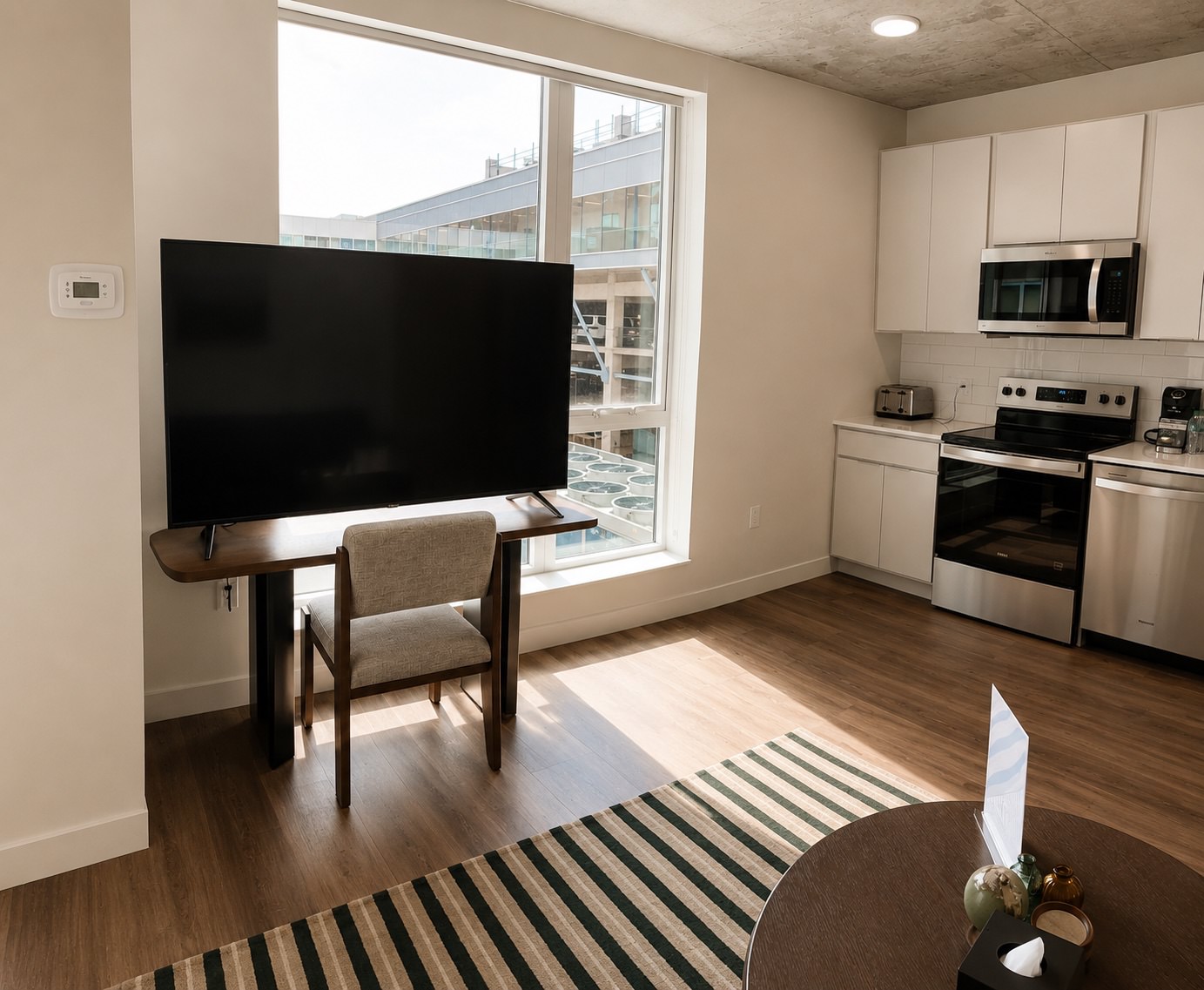 Spacious kitchens with thoughtful details a kitchen with white cabinets and a tv