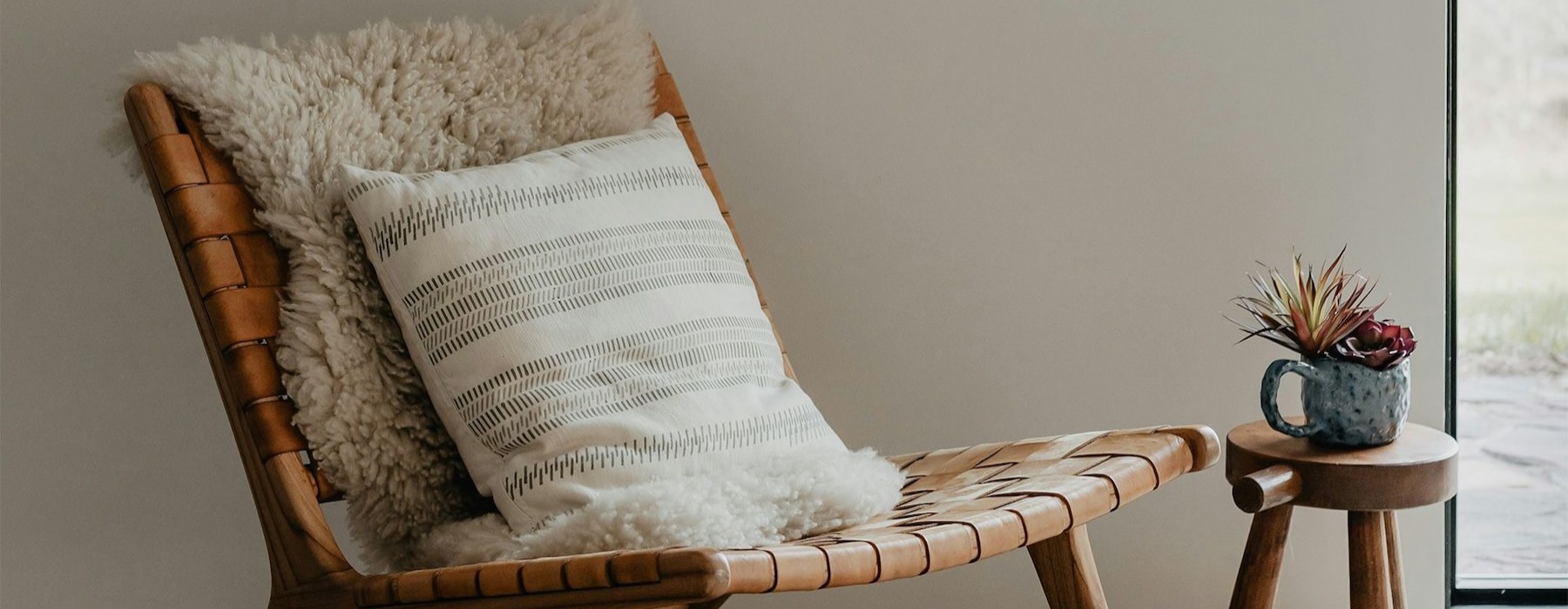 a chair in a room next to a pillow
