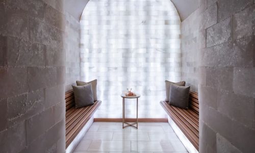 a room with wooden benches and a small table